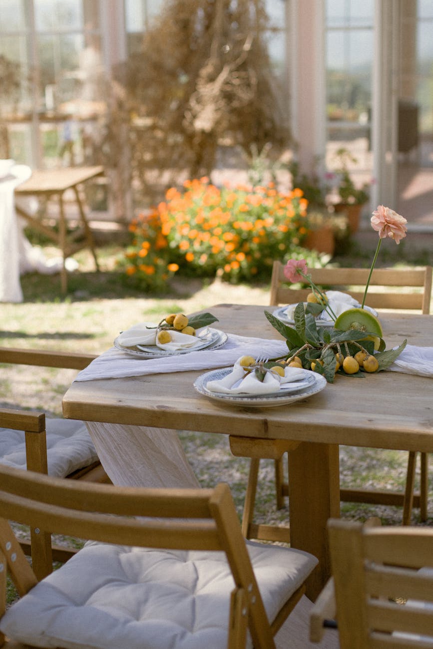 view of tableware and fresh fruit on the table in the garden